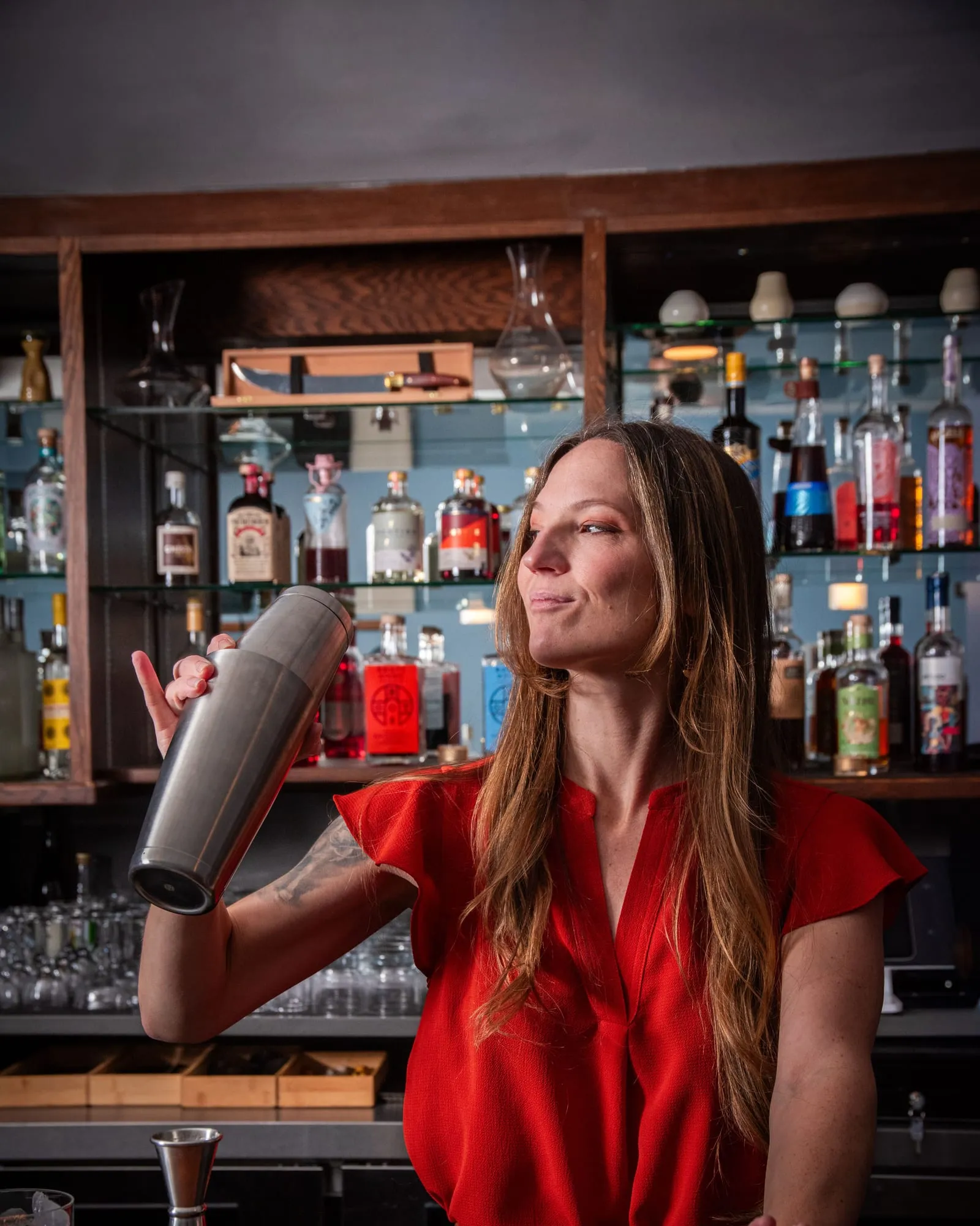 Ali Martin shaking a cocktail behind the bar
